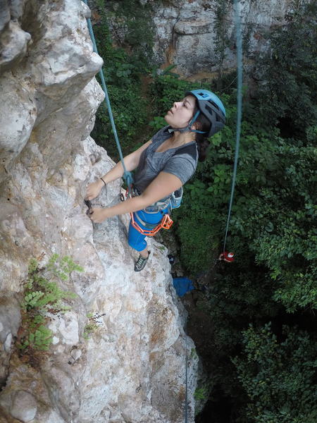 Resting on big holds after the crux and looking for the next move