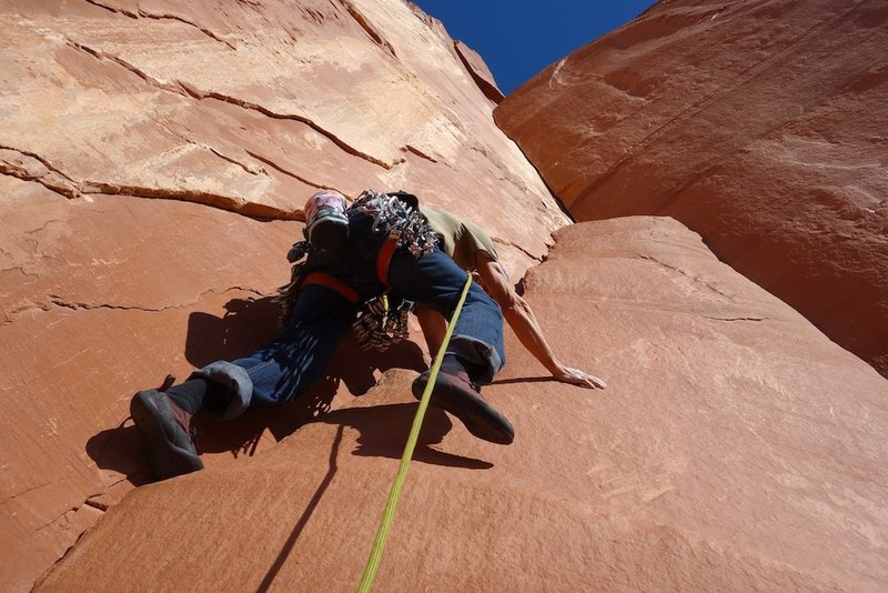 Starting up the pillar to access the corner on Pitch 1. You can also climb the right side of the pillar.