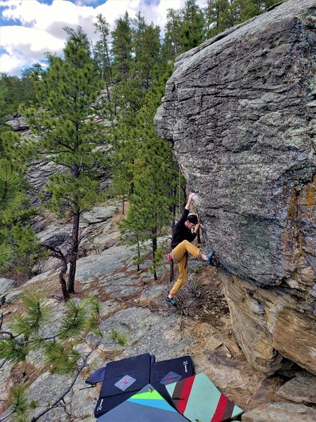 Andrew looking for a foot hold, or looking how far a fall will be?