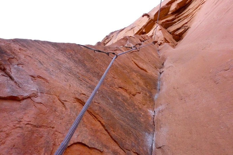 Looking up just before stepping out onto arete. The first sling you see is on a bolt out on the arete.