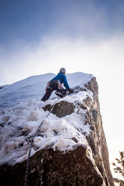 Clean lead ascent under 6" of snow! The face is slick enough when it's dry, let alone covered in snow and ice! The technique through the crux ended up being propping myself up on my knees while "campusing" between layback holds on the arete. Wild!