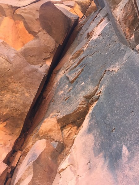 Upper section of the offwidth crack left of the line of bolts.