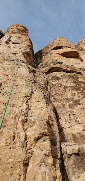 A climber on the route, which goes up near the arete.