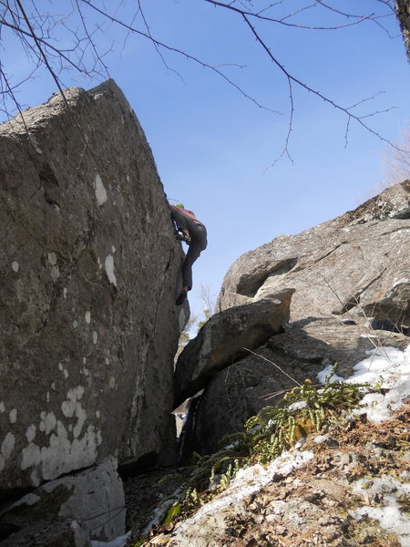 Mike Lee topping out "Eli's Crack" V1 on the backside of the Flintstone boulders