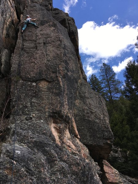 Climb the small crack to the left, top out on a bolted anchor