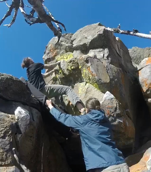 Good positioning for the crash pad as the climber moves up the route.