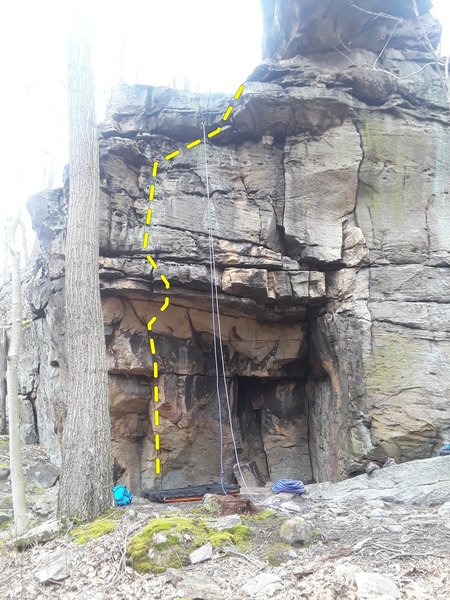 I found that getting to the small crack just below the overhang made it possible to get over the overhang. I cut my feet once I was over, but immediately got my feet back on the wall. Foot placement will help a lot.