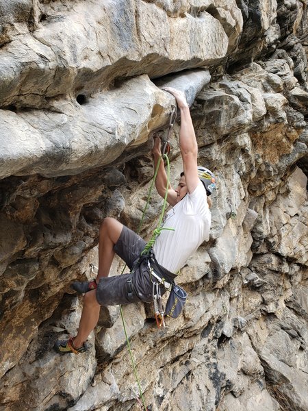 Cody approaches the crux roof of The Road, Fiscal Cliff.
