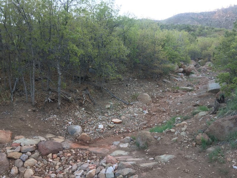 As noted in the comments, take this gully to the base of the buttress for a mile. Don't leave the gully when you get in it, it'll drop you directly at the base.