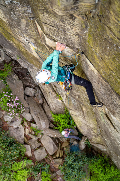 Pulling through on the Jugs after the crux.