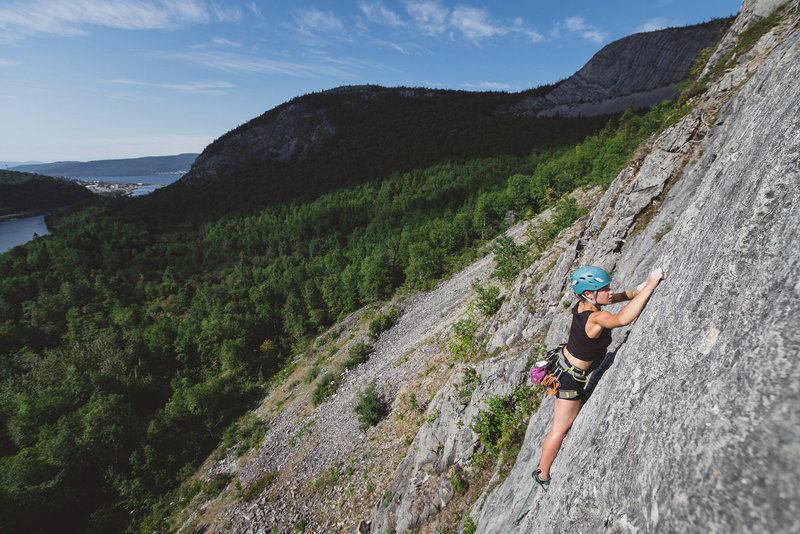 Megan Clarke on the sharp end of "Working Vacation 5.10b" at The Sunwall in the Humber Valley