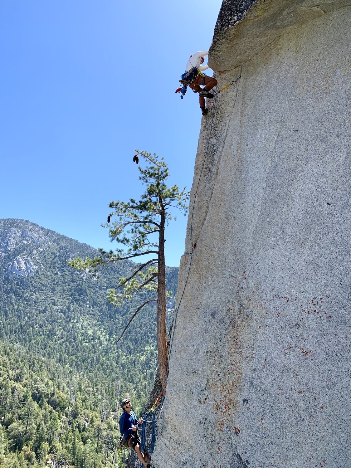 Jasen belaying as AJ (in approach shoes) goes after the overhang.