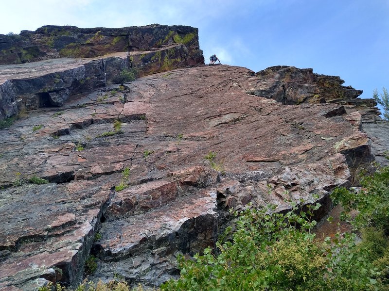 Looking up Magnum face from slight right of the belay. If I read it correctly, Snake Eyes is the arete to the left and Blue Steel is the arete to the right.