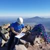 Signing the summit register.<br>
Photo Credit: Shane Slover