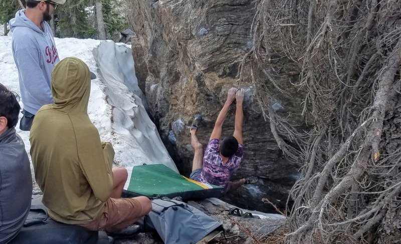 Sam on solid crimps after the low crux in late June with snow dug out.