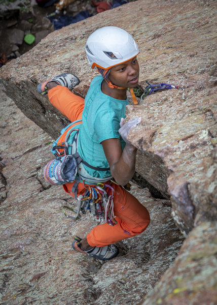 Sasha transitioning around the arete to the face halfway up the climb