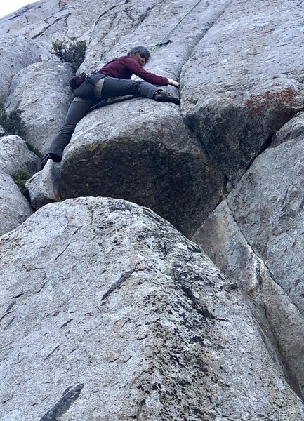 Michelle Kelley at what we thought was the crux move, stepping over the 1st bolt above the roof over to the seam.