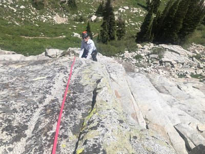 Climbing the final slab of Sticky Geranium