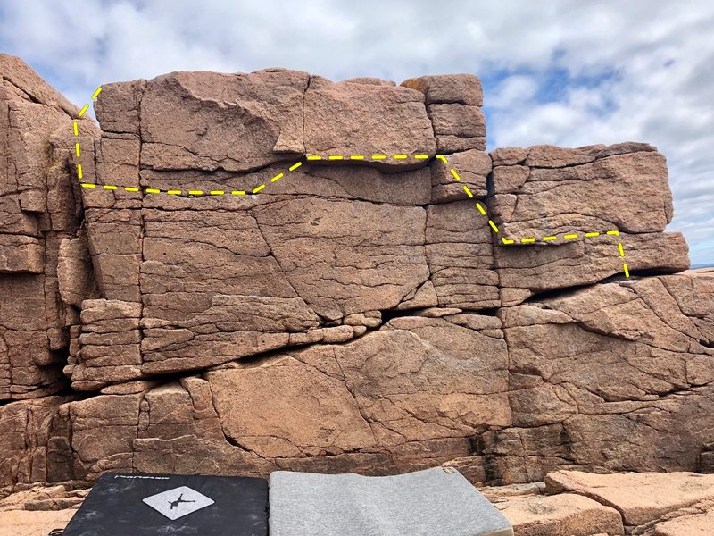 Begin on the farthest-right opening and work your way across to the crack on the left. Top out on using the slabs sticking out of the crack.