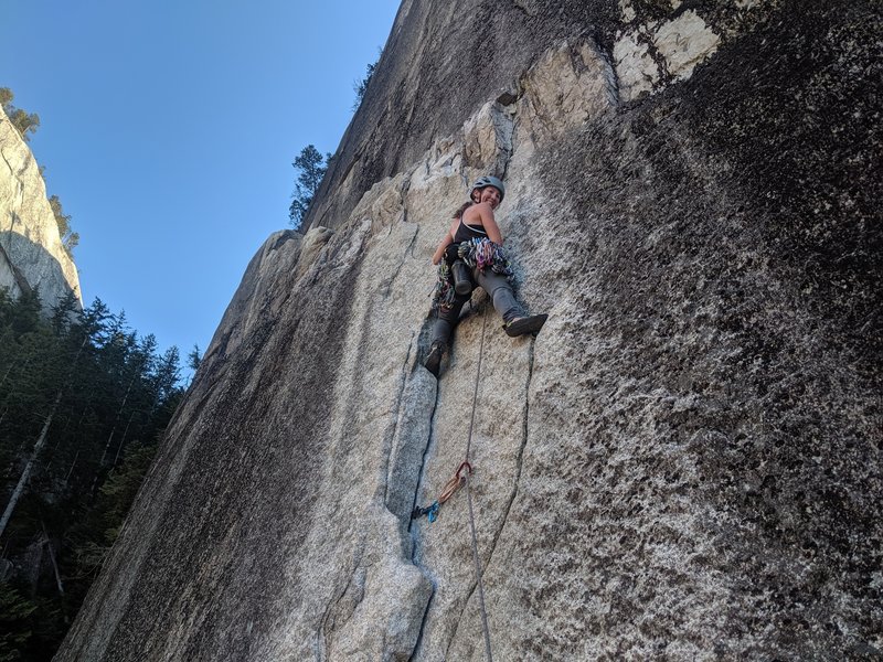 Michelle at the start of the pitch. she traversed that ledge past the first set of anchors to the second by a tree