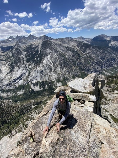 Topping out on the South Face. Go around the westside of the summit block and down it's backside to descend.