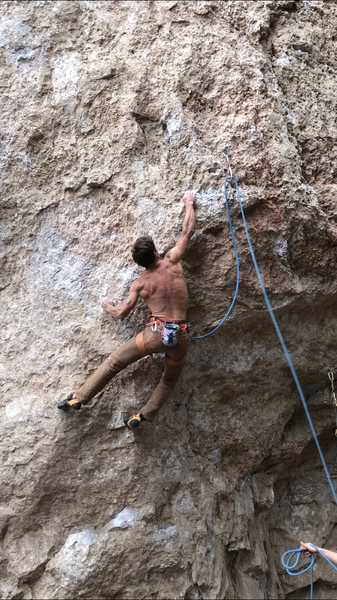 French American Climber Camille sticking the hardest move of the route which just so happens to be right off the ground!