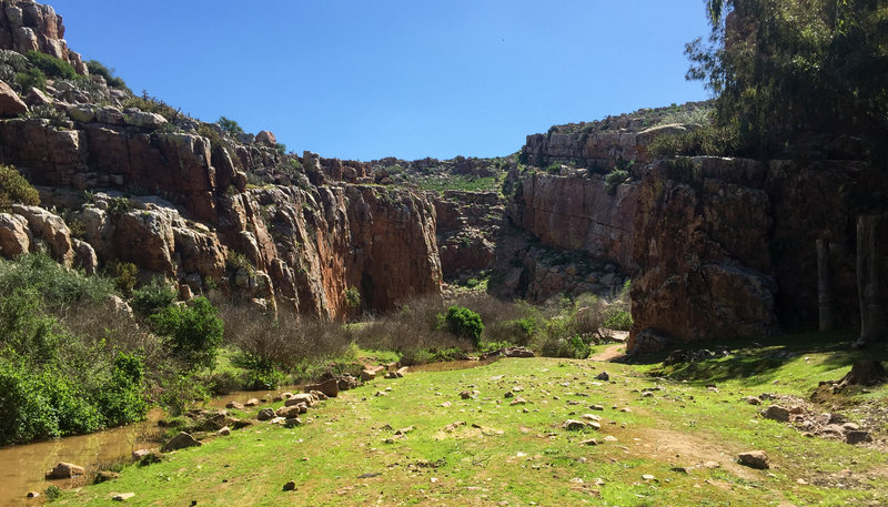 Ain Belmusk, as seen from the parking area. Majority of routes are on the right side of the canyon on the large shaded wall.