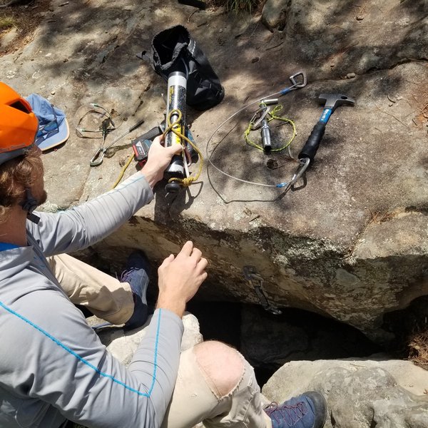Chase installing the anchor near the top of the catacombs