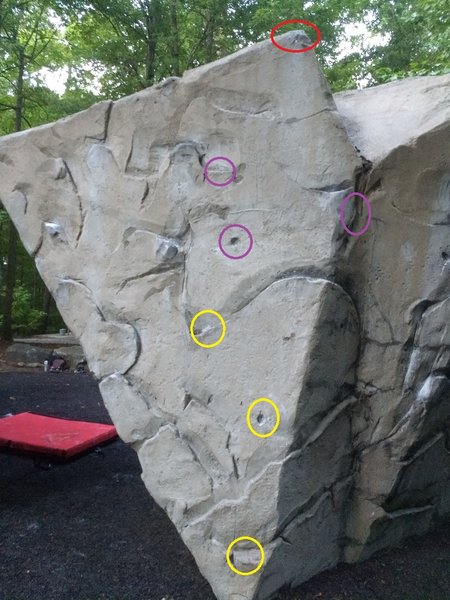Start yellow. The lower pocket is an undercling, upper pocket a thumb, and a sidepull on the right side. Only use pockets for further footholds.