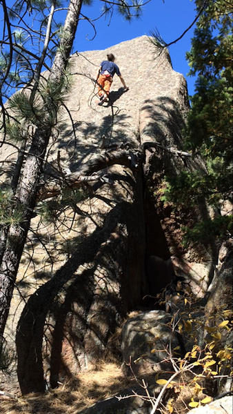 "Grand" V2 hb, with an alternate start through the crack/dihedral that is hidden in shadow. On the Teton boulder. Oct. 2019.