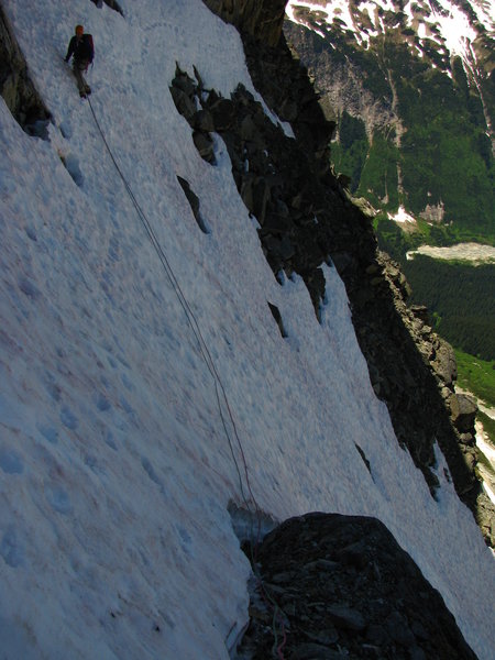 Traversing the snowpatch below the Gnomon. Once the snow is gone, this is a rubble ledge.