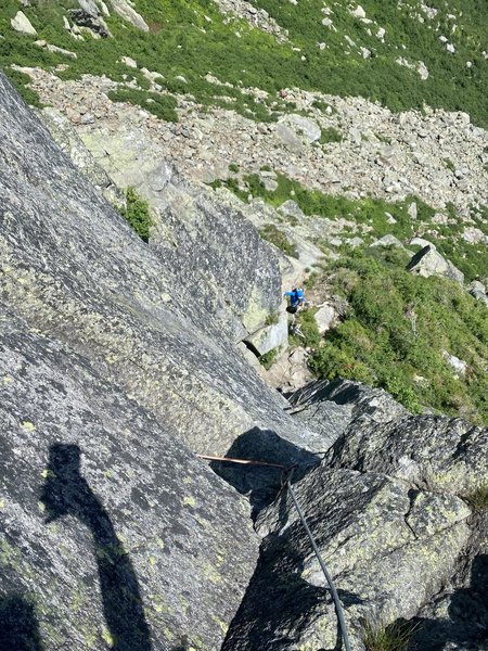 Looking down the slippery corner/awkward mantel pitch,. Belay on small gear.