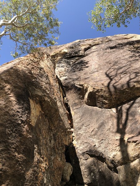 Start in the crack between pillar and cliff. Can clip second bolt from top of pillar