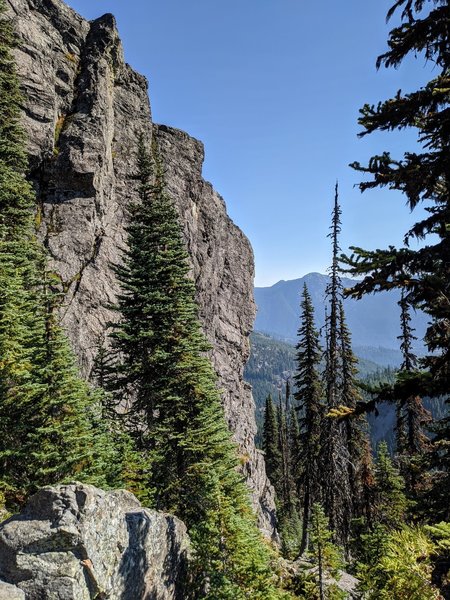 The left-side of the East Face @ Keechelus Ridge. The climber (barely visible in the center of the image, about 2/3rds the way up) is starting on the second pitch of Black Systems Solar.