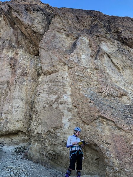 Climber standing under climb.