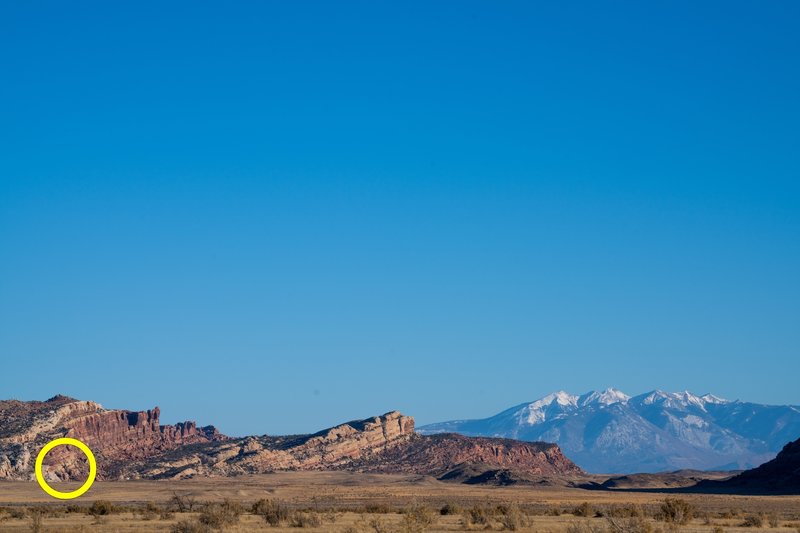 The Sunshine Wall (red wall on the left) with the La Sal mountains in the backdrop as seen from the drive in. The circled area is where we found lots of intermediate sport climbing and Dislaberal, a short, 5.6 trad route for beginner leaders.
