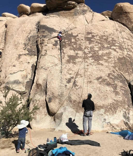 This route makes for a good beginner toprope for kids. My 4 year-old daughter is having fun climbing the crack. She started near where my shadow is.