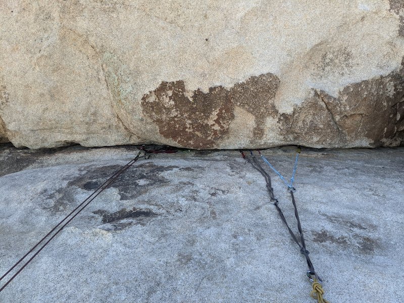 Gear anchors set in horizontal crack that lies above "The Bong" and several of its adjacent routes. Crack on large ledge set 20+ feet from the top of the climbs.