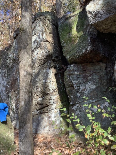R. Crumb climbs the arete and face of the boulder to the left of the wide crack.