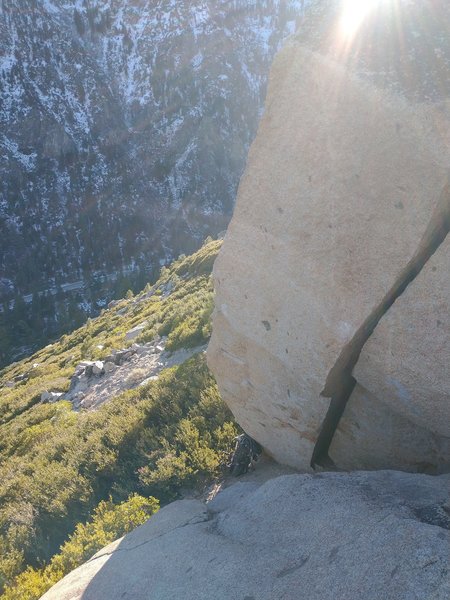 Striking ~20' arete on a boulder just down and to the left of Arrowhead. The compression moves toward the top hang over adjacent boulder.