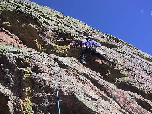 Warren Teissier starting the E. Face traverse towards the top of the Dog's Head.<br>
<br>
Photograph by George Bell.