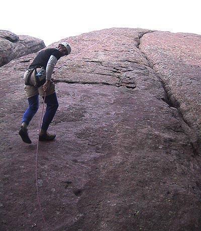 Mark Oveson rapping off ye old historic bolt (backed up to another rope above). Crescent Crack is the big crack to the right.