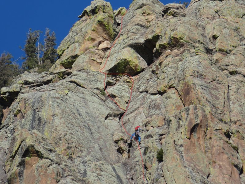 Pitch 4. The gully. Yes, he is stepping onto a sketchy rock. It can be avoided.