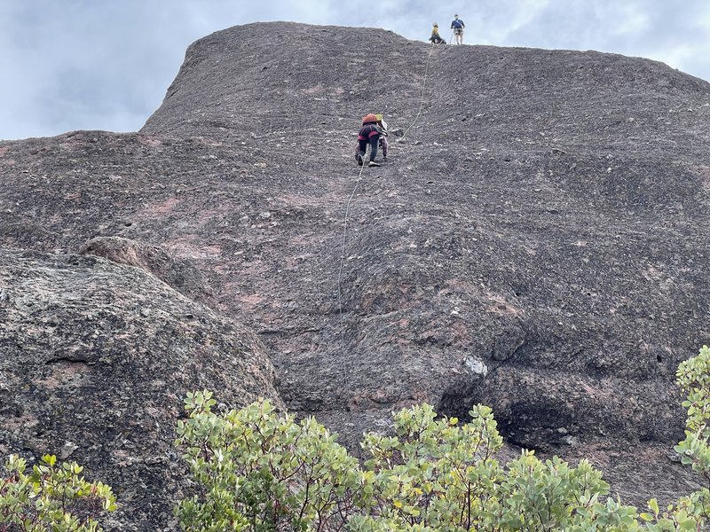Our third of four people heading up center route nearing the first bolt. Did the climb in one long pitch (our 50 meter rope barely reached the top). Rappelled using two 60m ropes.