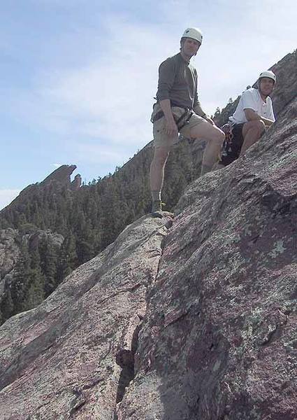 Mark Oveson and Warren Teissier near the summit of the Tiny Tower. The crack in the foreground is the top of the route (and the descent route). In the background on the skyline is the Maiden.