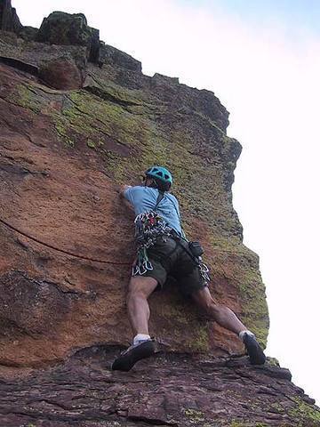Bill Wright begins to move left after making the reach up to the high horizontal crack. From the angle of the rope, one can see a fall from here would not be fun. This photo is about 4' farther right than the last.