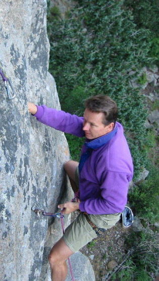 Ken Leiden clipping the bolt just before the crux.