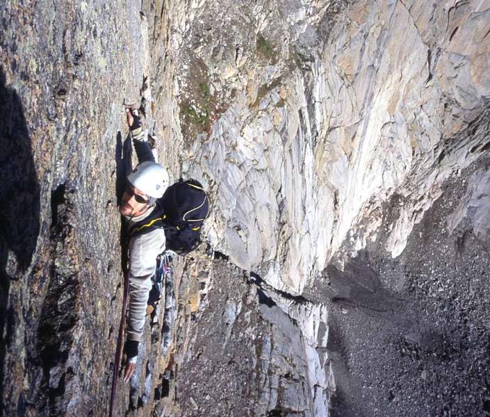 The end of the first traverse. The North Chimney is visible below as well as a pair of climbers on Broadway preparing to start the D1 Pillar.