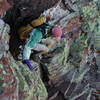 Kelly down climbs a colorful dihedral typical of the scrambling on the route.