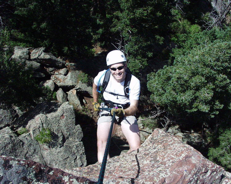 "RAPPEL 75 FT NORTH." A very white man going off the summit.